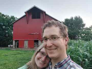 Amanda and Benjamin in front of barn